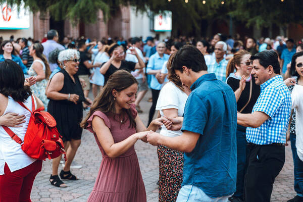 Attendees dancing at a church social event