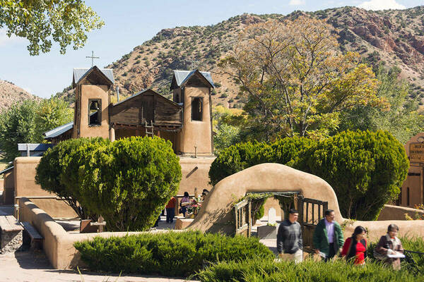 Photo of El Sanctuario de Chimayó showing the grounds entrance and church.