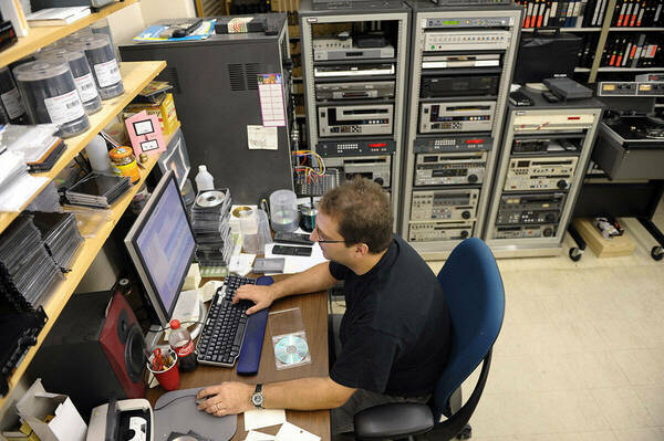 Eric Dix works at a computer in the Notre Dame Archives.
